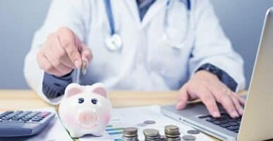 Doctor with piggy bank - financial planning